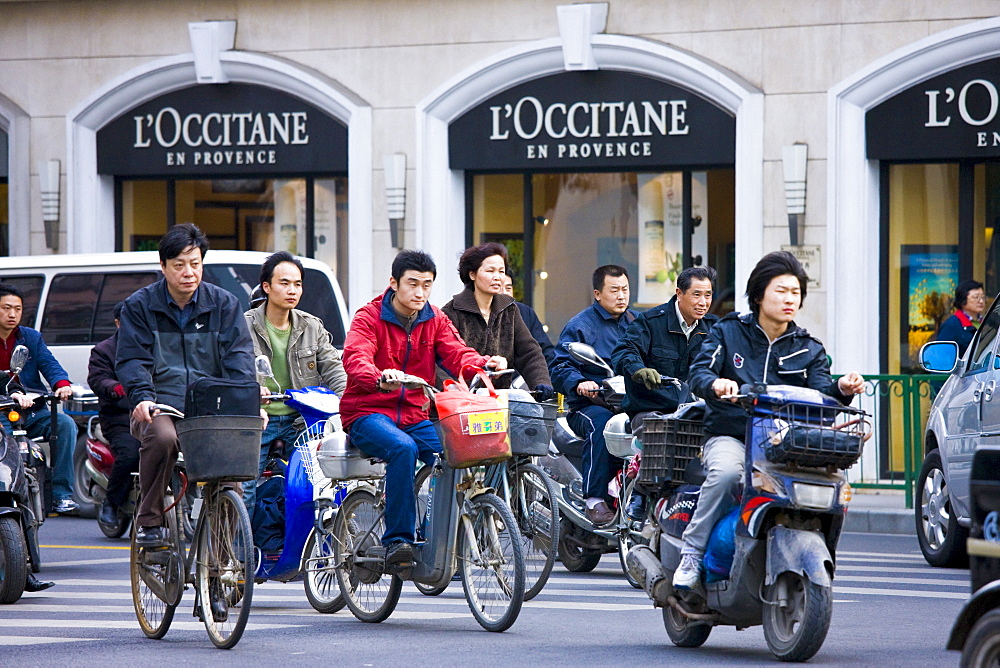 Scooters and bikes on Nanjing Road, central Shanghai, China