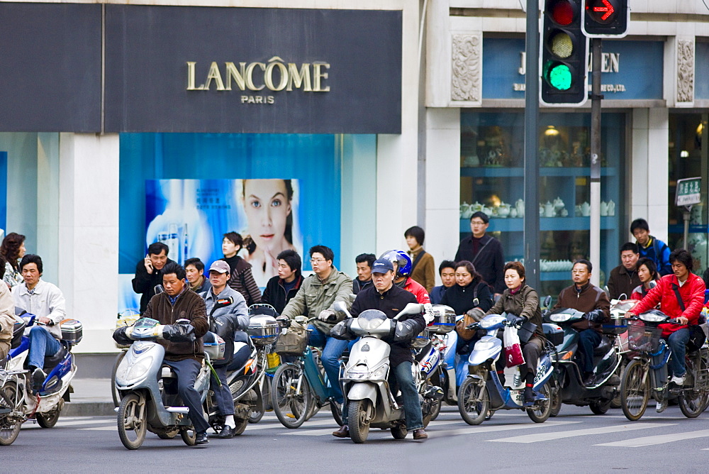 Scooters and bikes on Nanjing Road, central Shanghai, China