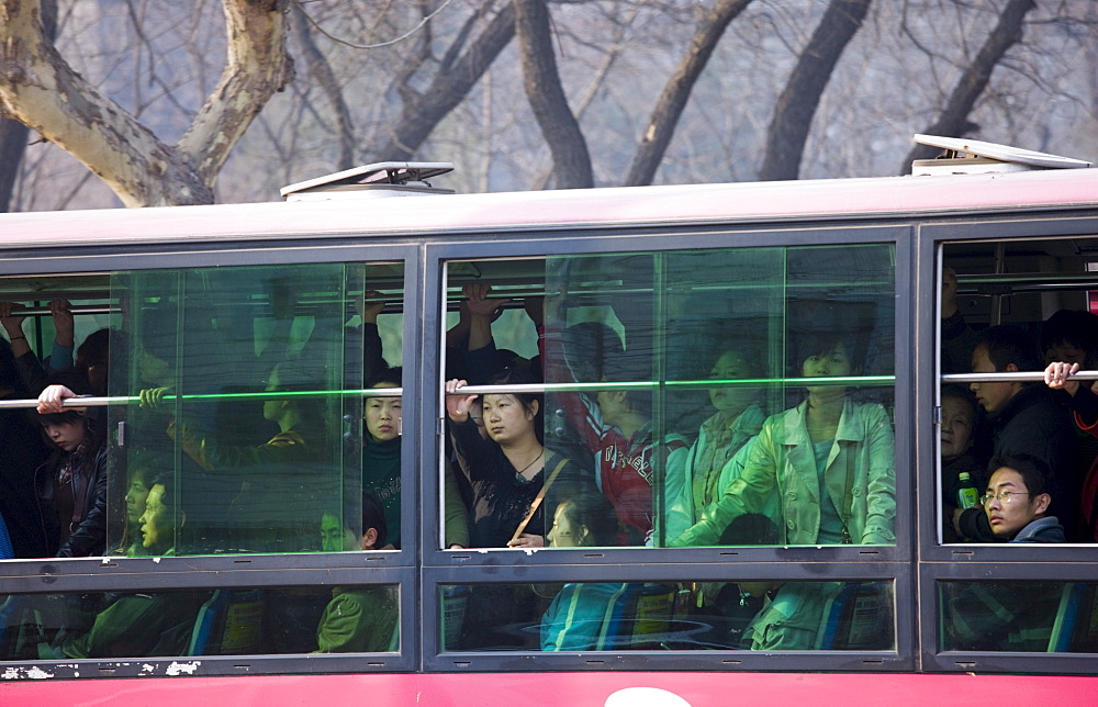 Bus carries workers home in rush hour, Xian city centre, China