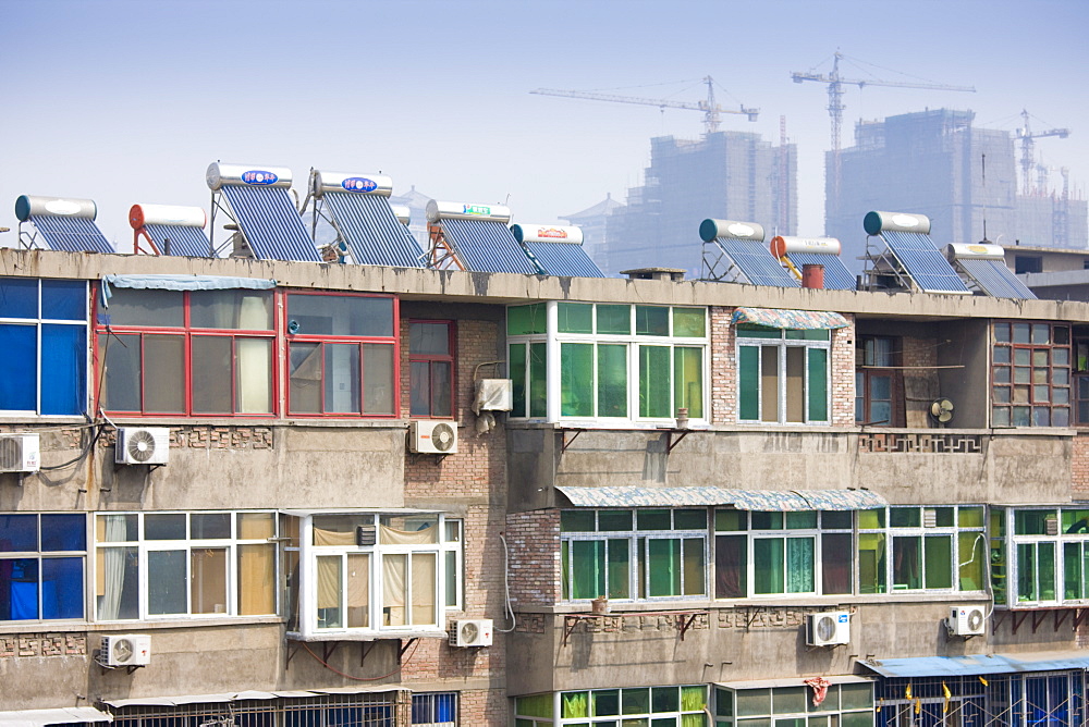 Solar panels and air conditioning on apartments next to the City Wall, Xian, China