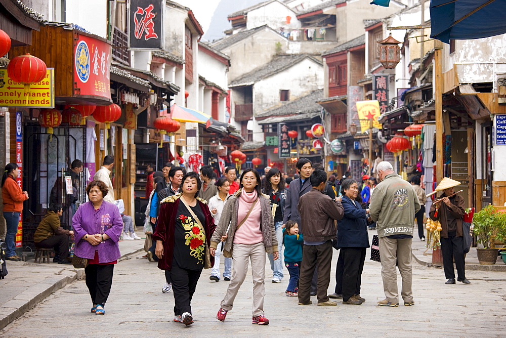 Chinese tourists in crowded shopping street in Yangshuo, China