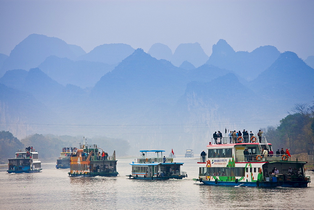 Tourist boats travel along Li River between Guilin and Yangshuo, China