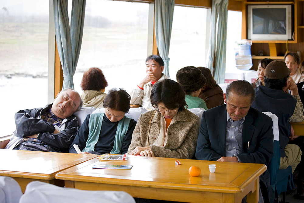 Tourists sleep as they travel by boat along Li River between Guilin and Yangshuo, China