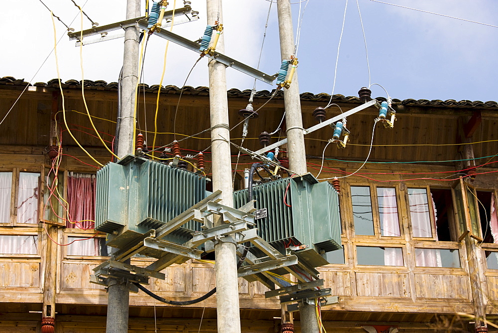 Telegraph pole with telephone and power lines installed in the mountain village of Ping An, Longsheng, near Guilin, China