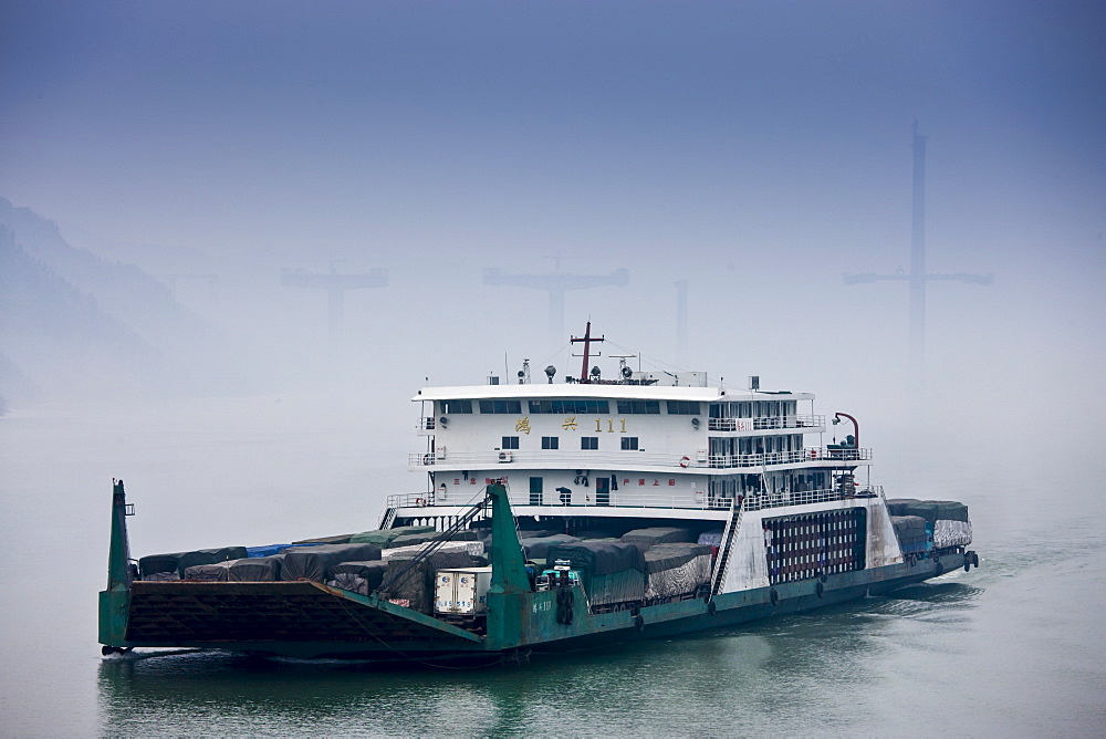 Transportation of trucks with freight and cargo, by boat on Yangtze River, China