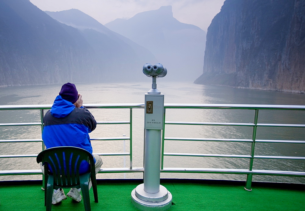 Tourist takes photographs from the deck of Victoria Line Cruise Ship, Yangze River, China