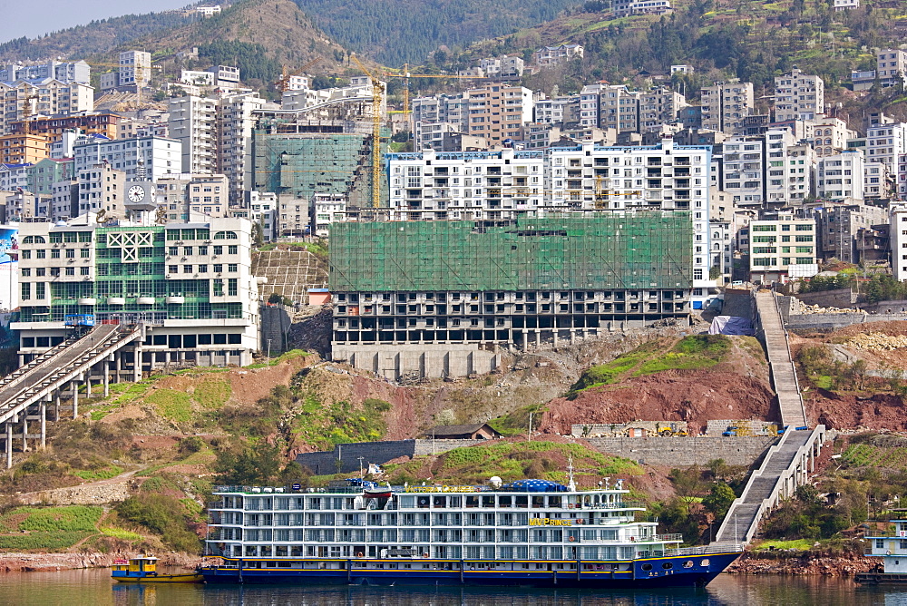 Victoria Line cruise ship by new town built to re-home communities as part of Three Gorges dam project, China