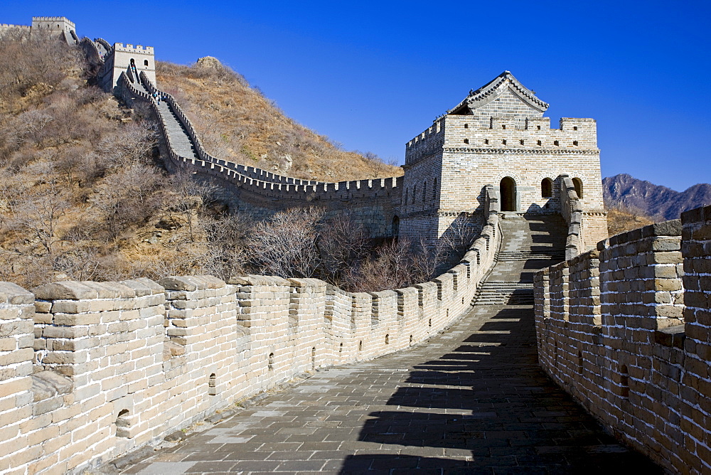 The ancient Great Wall of China snaking through mountains at Mutianyu, north of Beijing (formerly Peking)