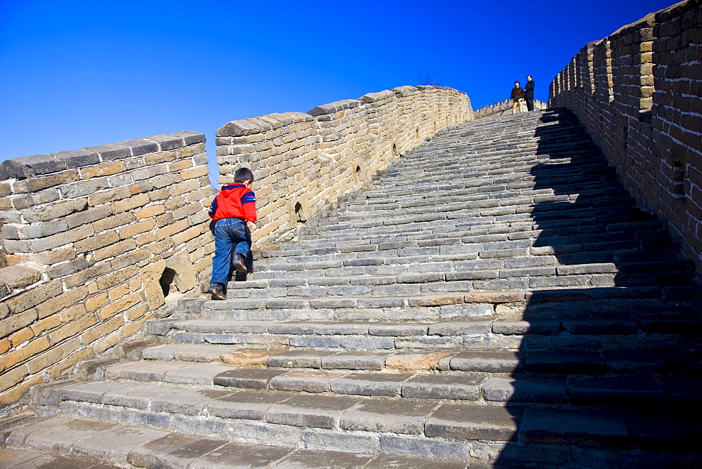 Chinese boy walking the Great Wall of China at Mutianyu, north of Beijing (formerly Peking)