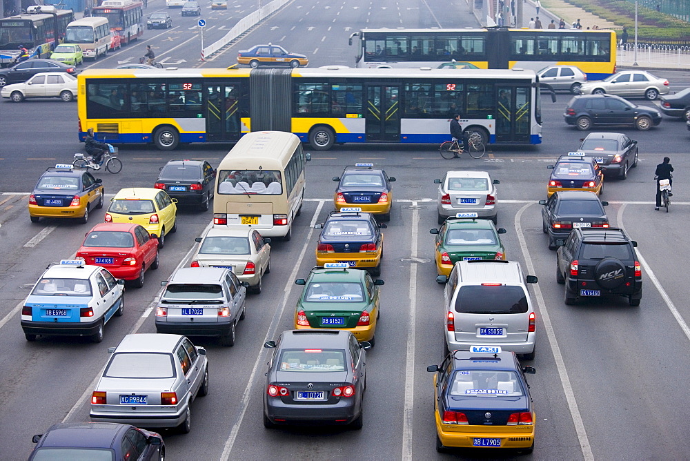 Bendybus and traffic on Beijing main street, China