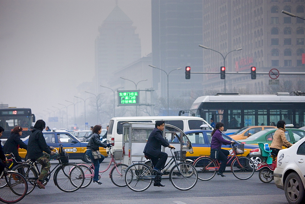 Cyclists and traffic on Beijing main street, Chang An Avenue, China