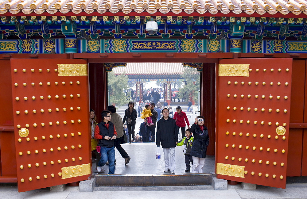 Tourists stand at gates to Tower of Buddhist Incense at The Summer Palace, Beijing, China