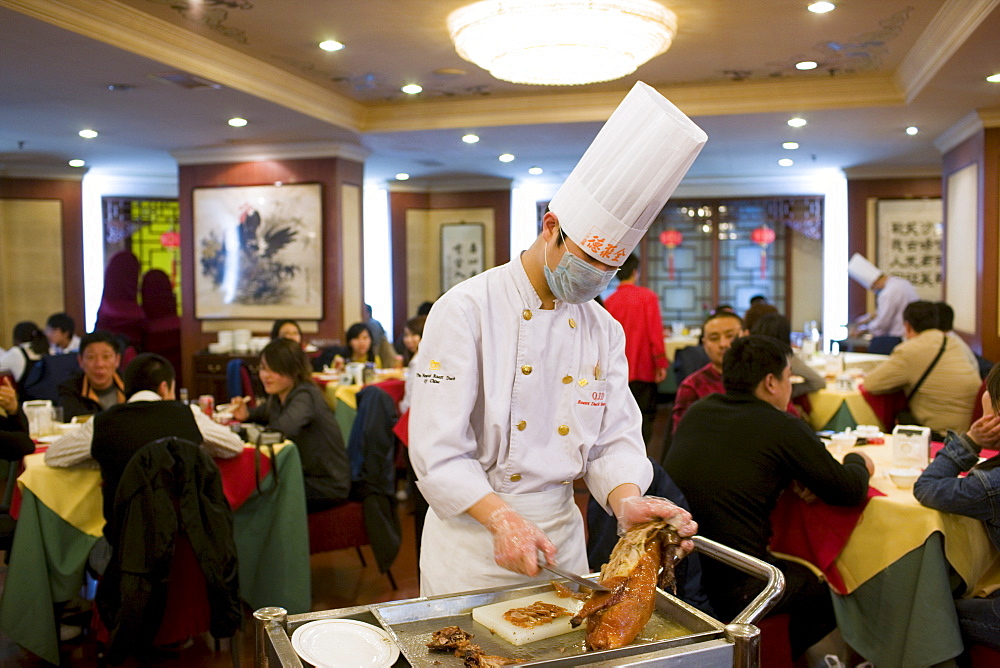 Chef prepares Peking duck in Quanjude Roast Duck restaurant, Wangfujing Street, Beijing, China