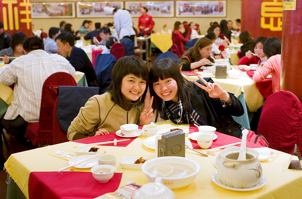 Two girls in Quanjude Roast Duck restaurant, Wangfujing Street, Beijing, China