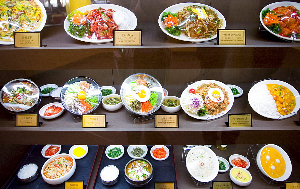 Plates of food on display in a Terminal Three restaurant of Beijing Capital International Airport, China