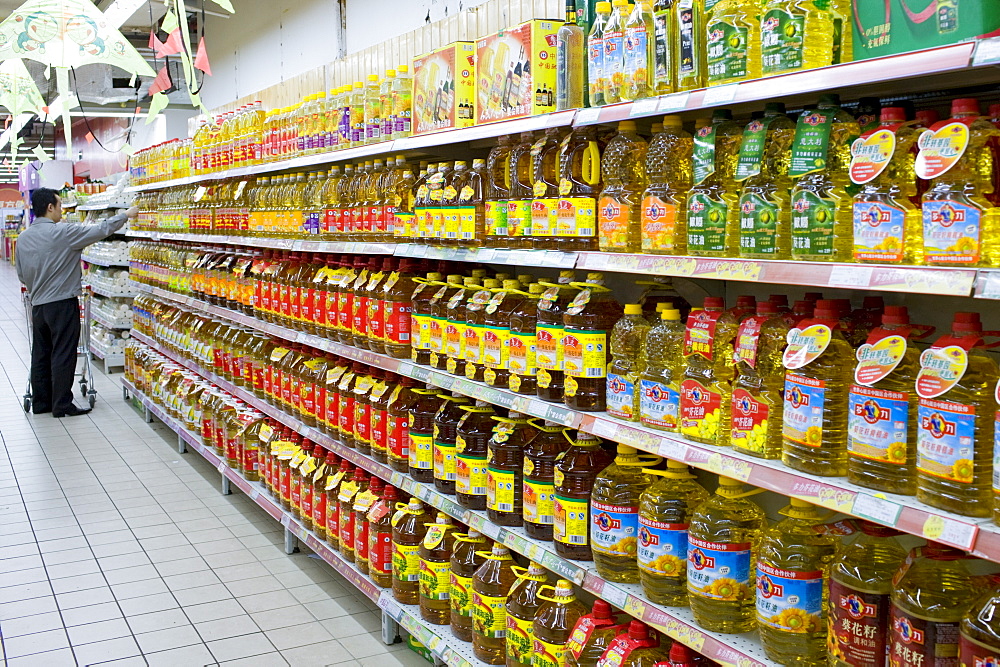 Cooking oils in supermarket, China. The Chinese use a lot of edible oil and find it an expensive item.