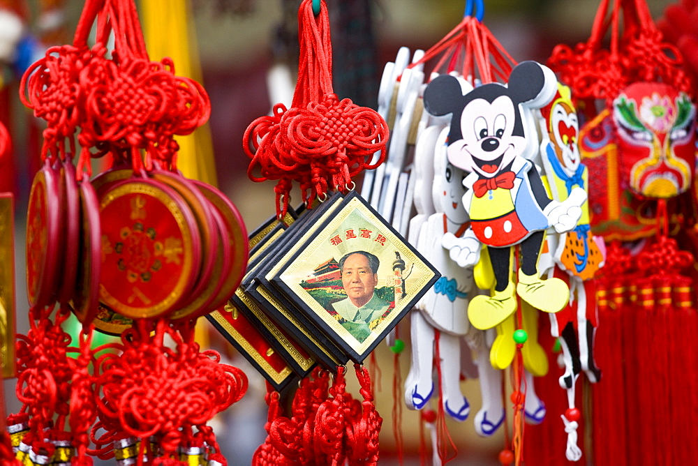 Souvenirs including Chairman Mao keyrings and Mickey Mouse toys on sale at Mount Baoding, China