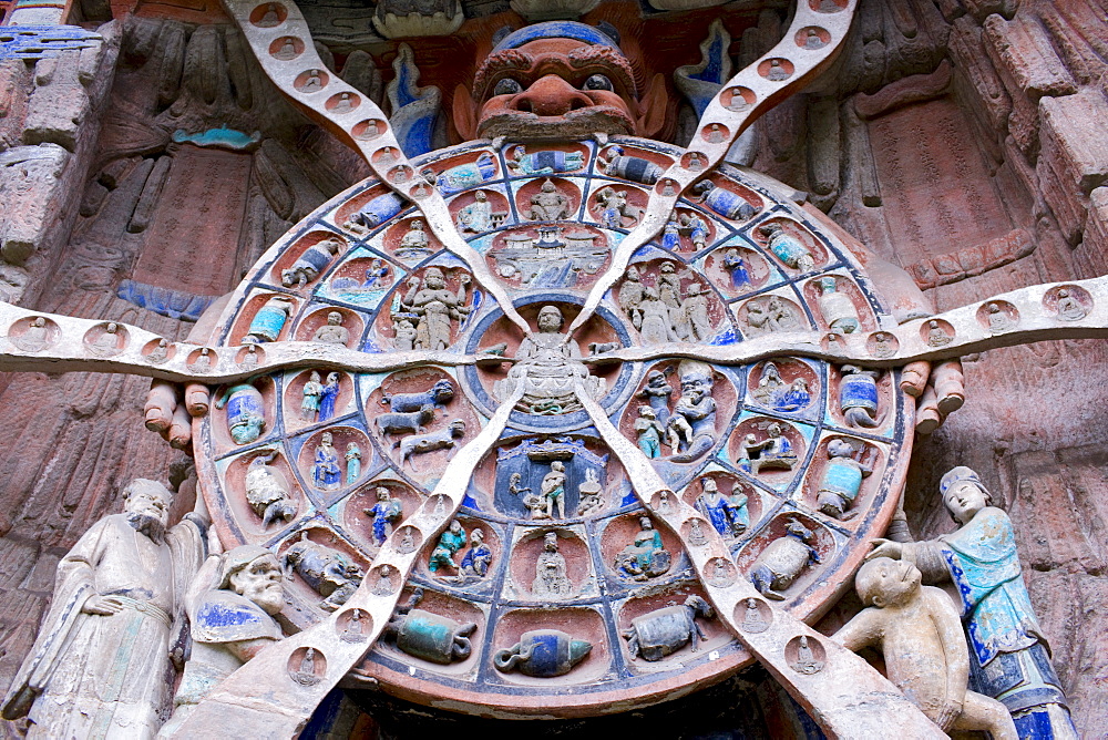 Anicca, God of Destiny holds wheel of life of Buddhist Karma, Dazu rock carvings, Mount Baoding, China