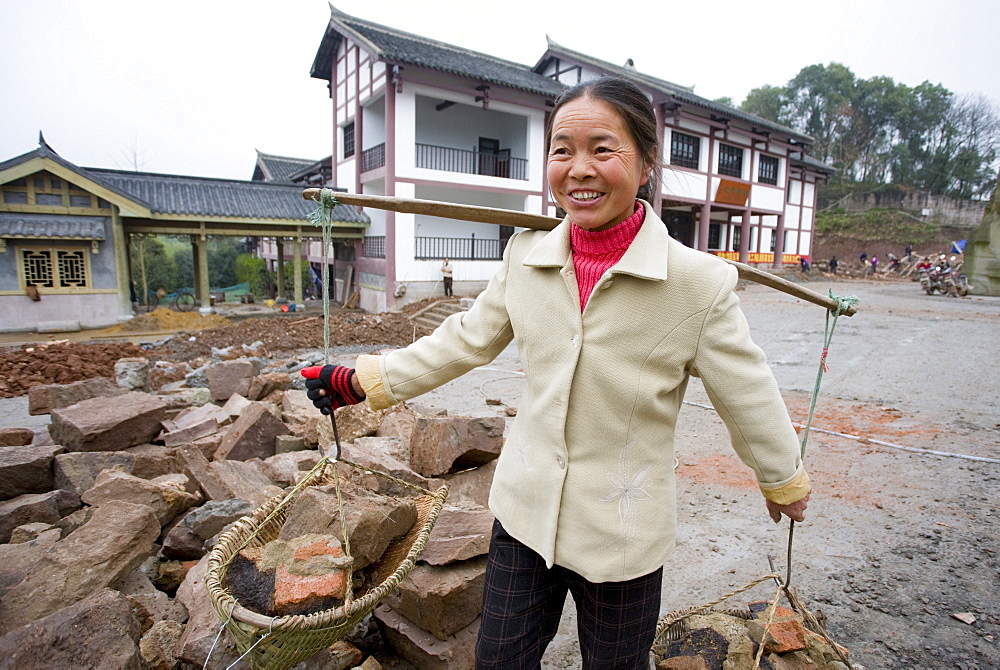 Woman at work building new tourist centre at Dazu Rock Carvings, Mount Baoding, Chongqing, China