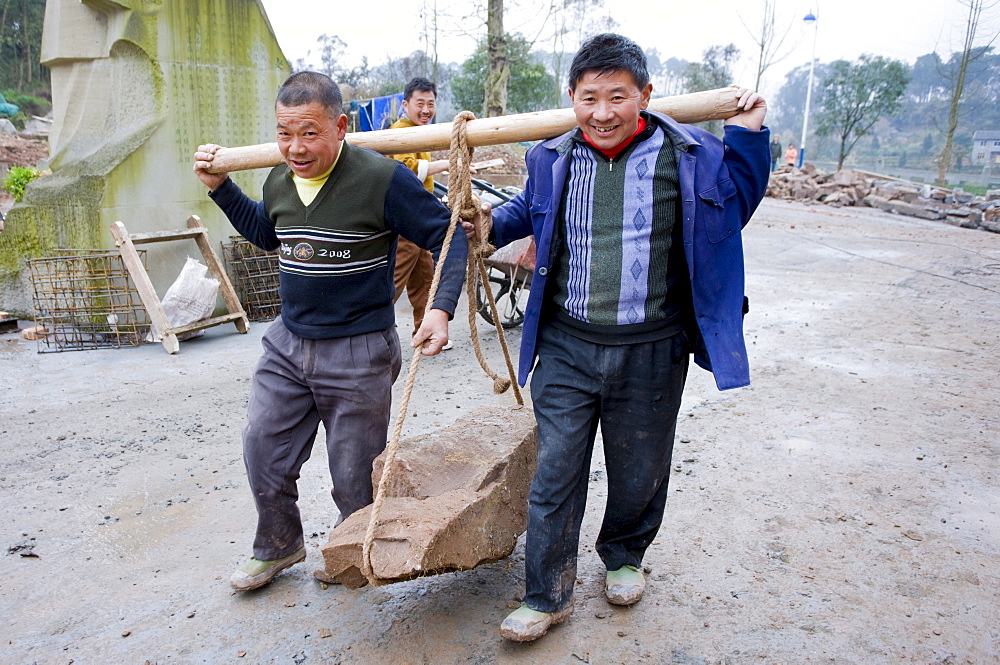 Men at work building new tourist centre at Dazu Rock Carvings, Mount Baoding, Chongqing, China