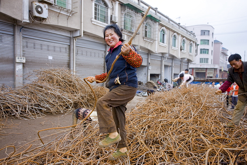 Woman working at metal recycling steel in Dazu County, Chongqing, China