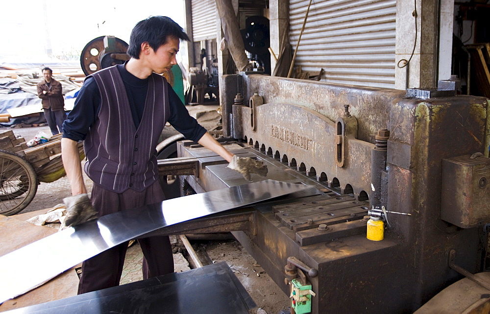 Man working at metal recycling steel in Dazu County, Chongqing, China