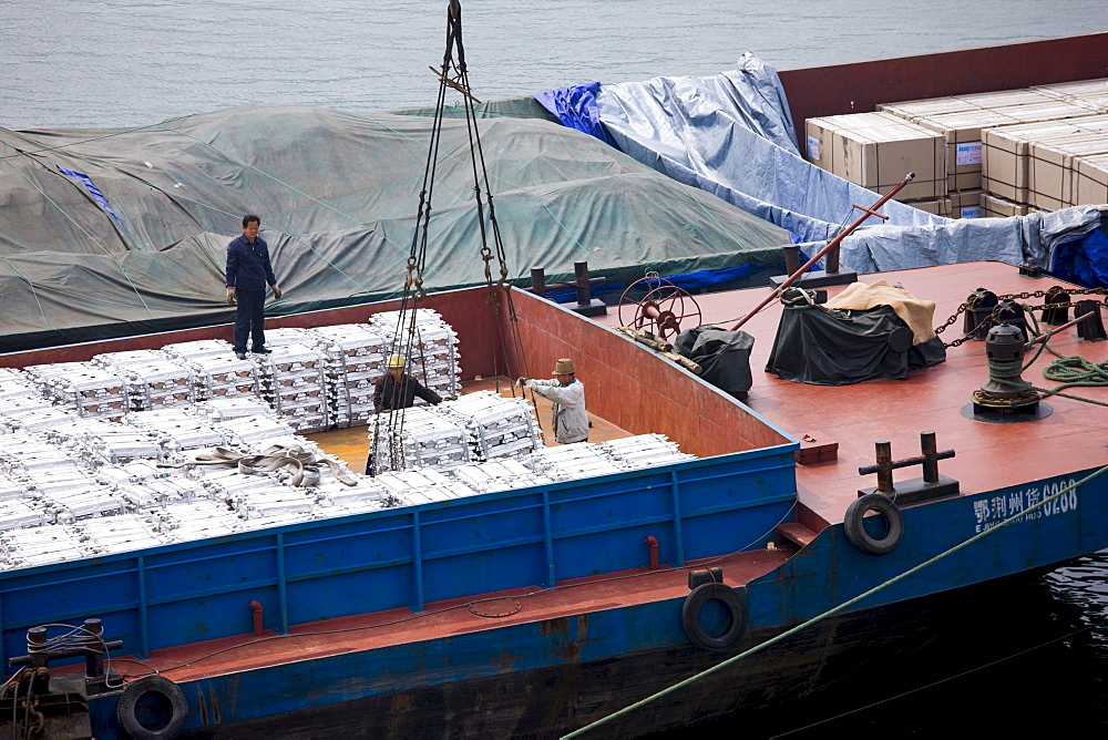 Aluminim ingot blocks being loaded onto cargo ship, Yichang, China