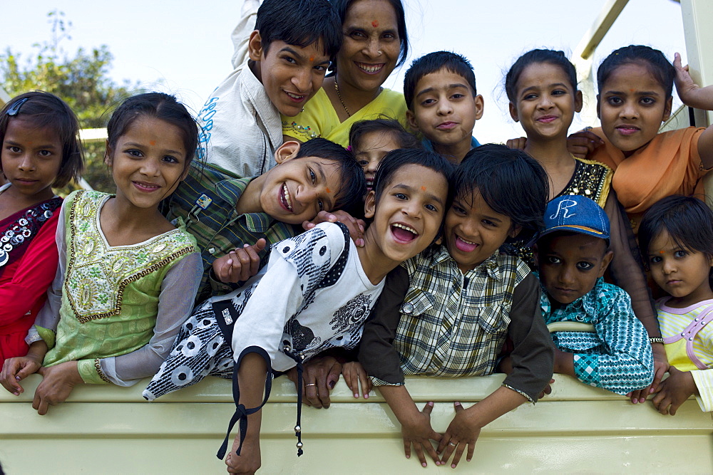 Indian children in back of TATA truck at Mehrauli, New Delhi, India