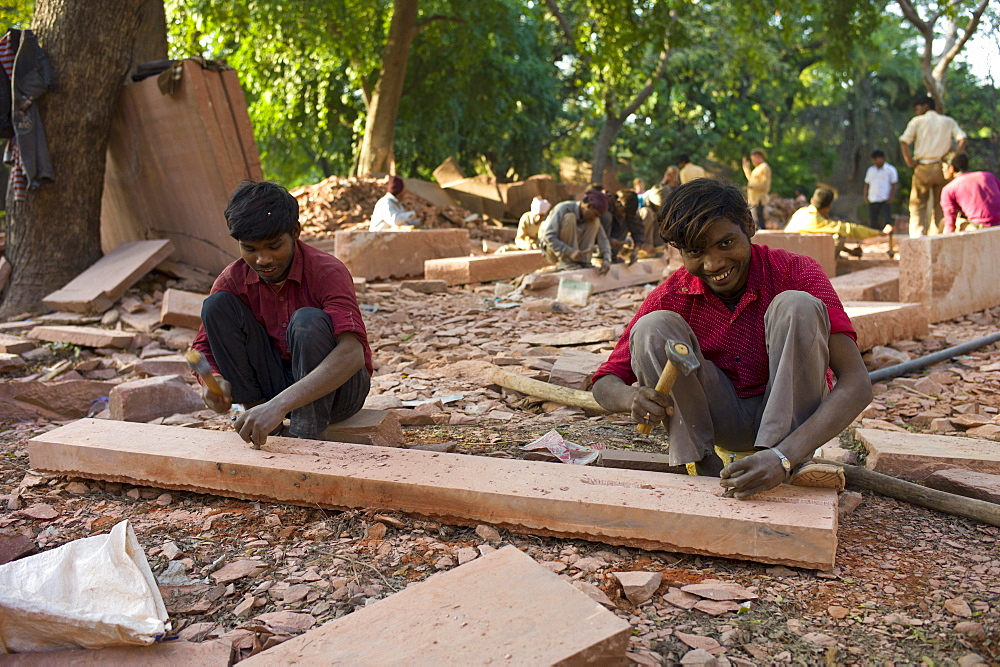 Stonemasons using traditional manual skills at stone workshop at Humayuns Tomb,  in New Delhi, India