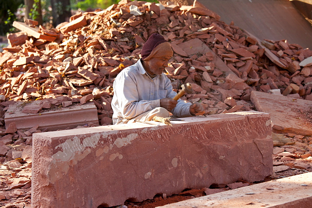 Stonemason using traditional manual skills at stone workshop at Humayuns Tomb,  in New Delhi, India