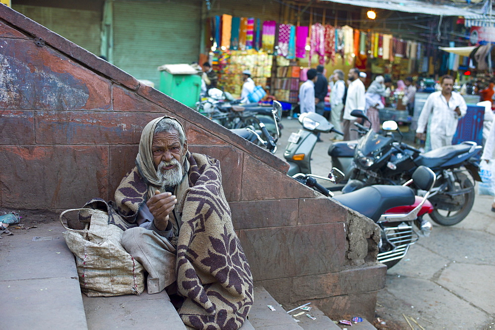 Indian beggar at muslim Meena Bazar, in Old Delhi, India