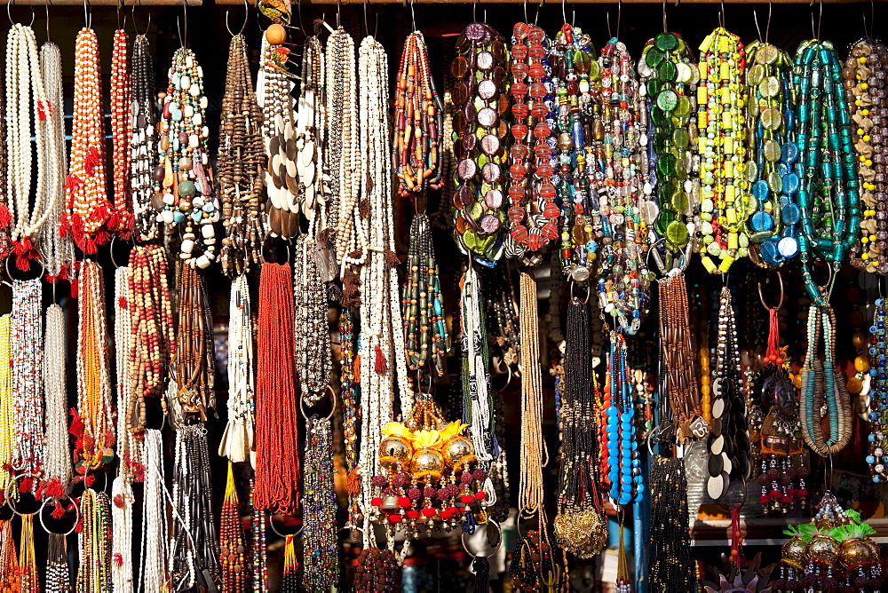 Traditional beads and necklaces on market stall in street scene in city of Varanasi, Benares, Northern India