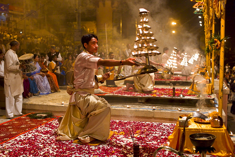 Hindu priests at sundown Aarti Ritual Ceremony of Light during Shivrati Festival in Holy City of Varanasi, Benares, India