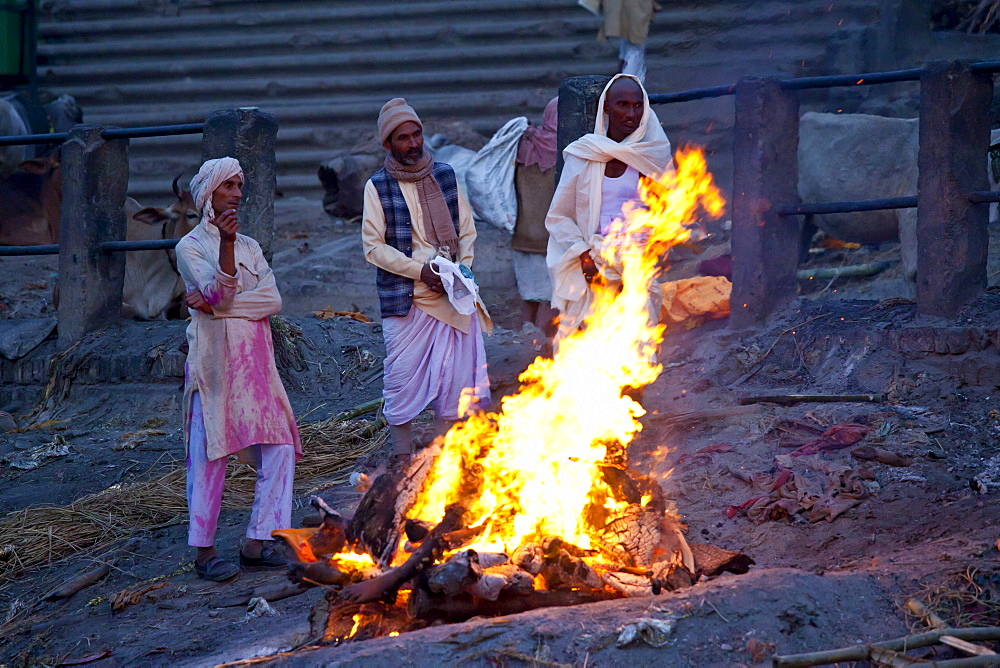 Body burning on funeral pyre at Hindu cremation at Manikarnika crematorium Ghat in Holy City of Varanasi, Benares, India