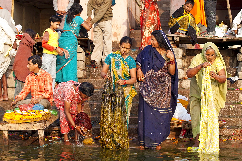 Indian Hindu pilgrims bathing in The Ganges River at Dashashwamedh Ghat in Holy City of Varanasi, Benares, India