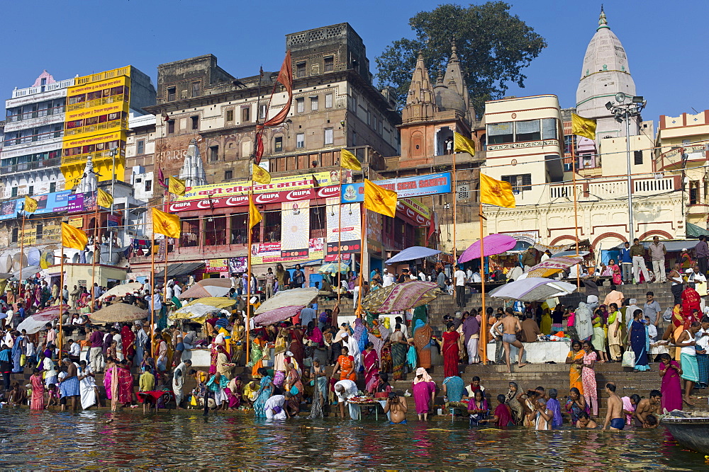 Indian Hindu pilgrims bathing in The Ganges River at Dashashwamedh Ghat in Holy City of Varanasi, Benares, India