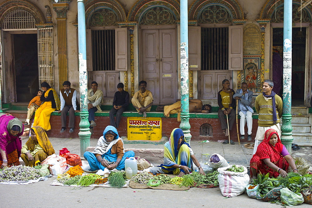 Women selling flowers and herbs for temple offerings by The Golden Temple during Festival of Shivaratri in holy city of Varanasi, India