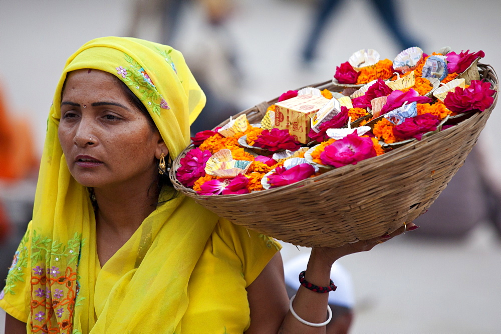 Indian Hindu woman selling ceremonial flowers and offerings during Festival of Shivaratri in holy city of Varanasi, India