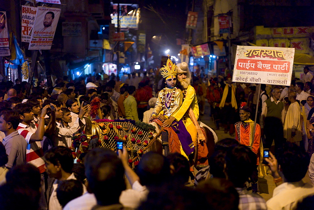 Lord Shiva and Parwati characters ride through crowd at Festival of Shivaratri in the holy city of Varanasi, Benares, Northern India