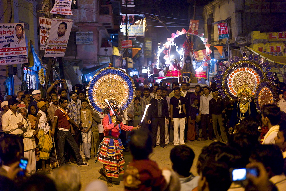 Costume characters with flaming torches in crowd at Festival of Shivaratri in the holy city of Varanasi, Benares, India