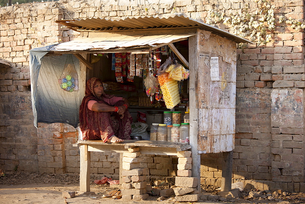 Indian woman stallholder selling sweets and toys at Sarnath near Varanasi, Benares, Northern India