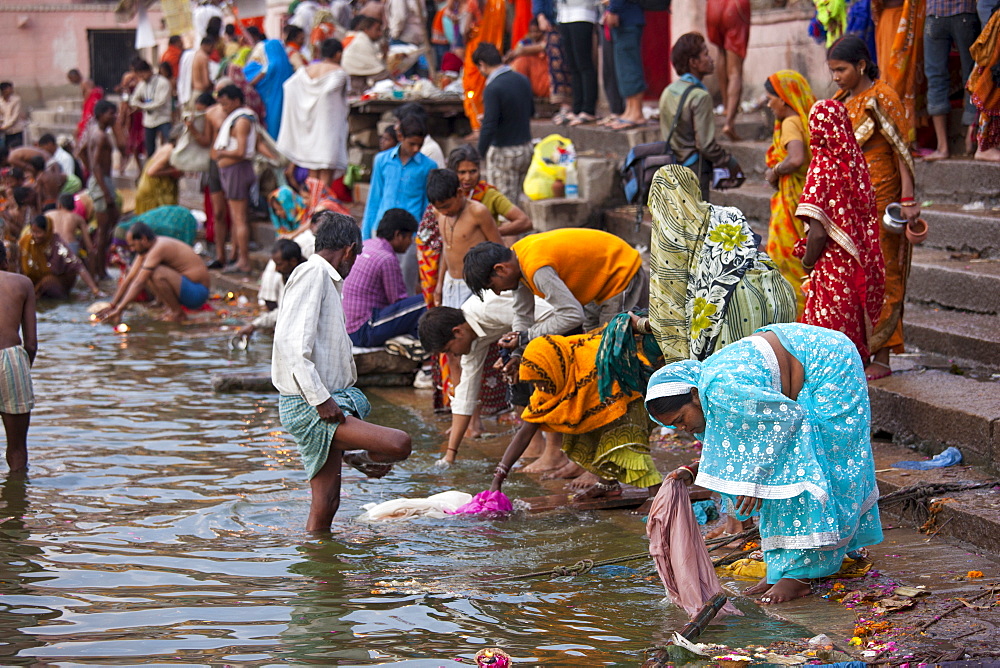 Indian Hindu pilgrims bathing in The Ganges River at Dashashwamedh Ghat in Holy City of Varanasi, Benares, India