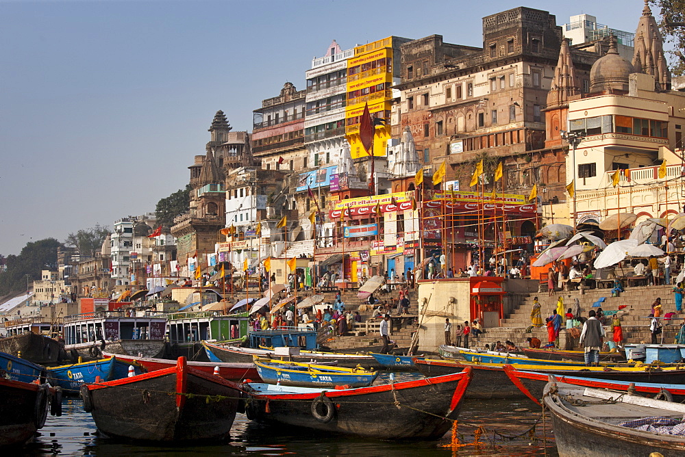 Tourist boats in The Ganges River at Dashashwamedh Ghat to watch Hindus bathing in Holy City of Varanasi, Benares, India