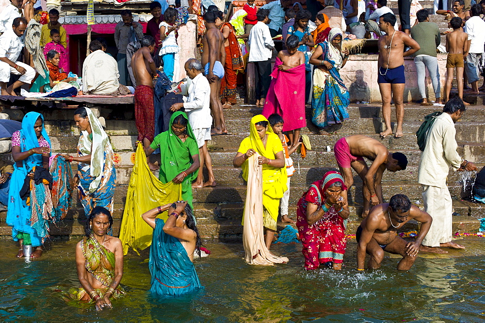 Indian Hindu pilgrims bathing in The Ganges River at Dashashwamedh Ghat in Holy City of Varanasi, Benares, India