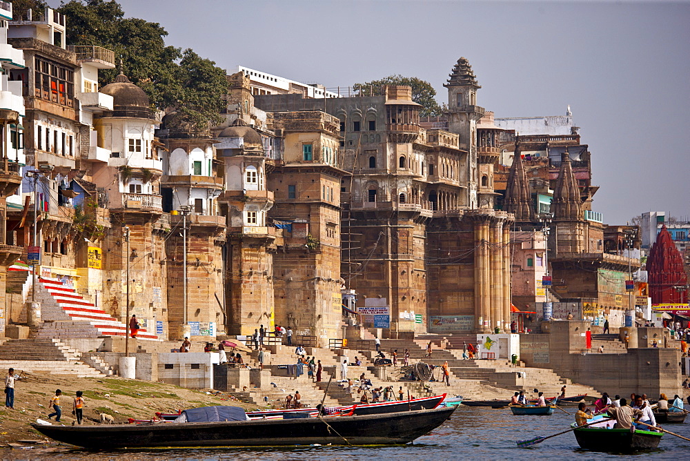 Tourists in boats at Ranamahal Ghat and Chousatti Ghat watch traditional bathing in Varanasi, India