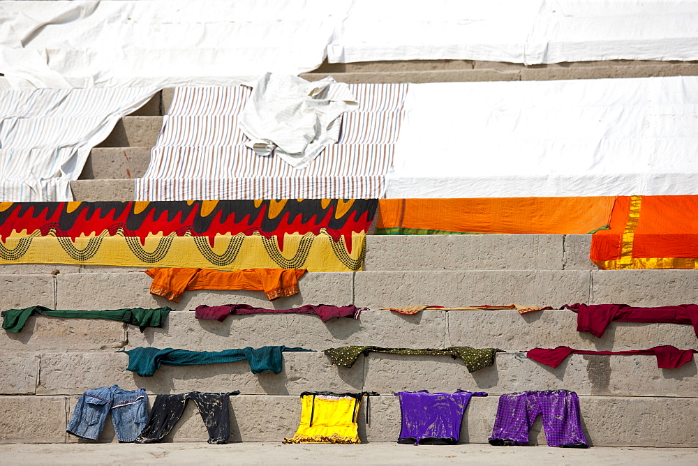 Laundry on the steps of the Ghats by The Ganges River at Kali Ghat in City of Varanasi, Benares, India