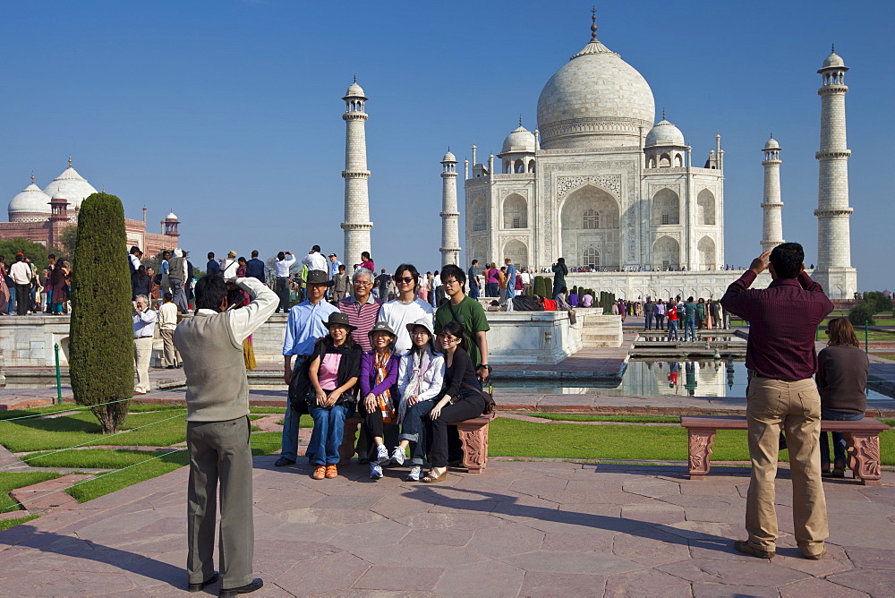 Tourists taking photographs at The Taj Mahal mausoleum southern view Uttar Pradesh, India