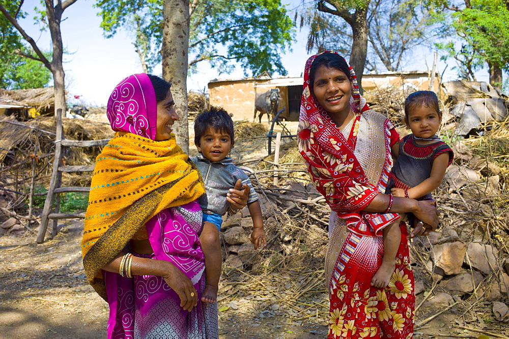 Indian villagers by farm smallholding near Ranthambore in Rajasthan, Northern India