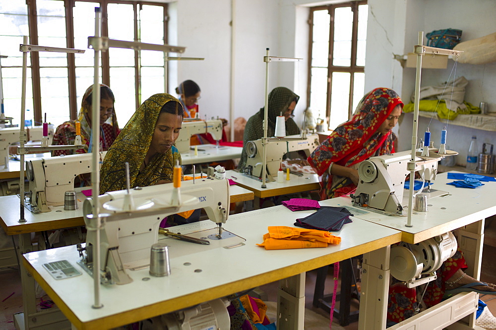 Indian women sewing textiles at Dastkar women's craft co-operative, the Ranthambore Artisan Project, in Rajasthan, Northern India