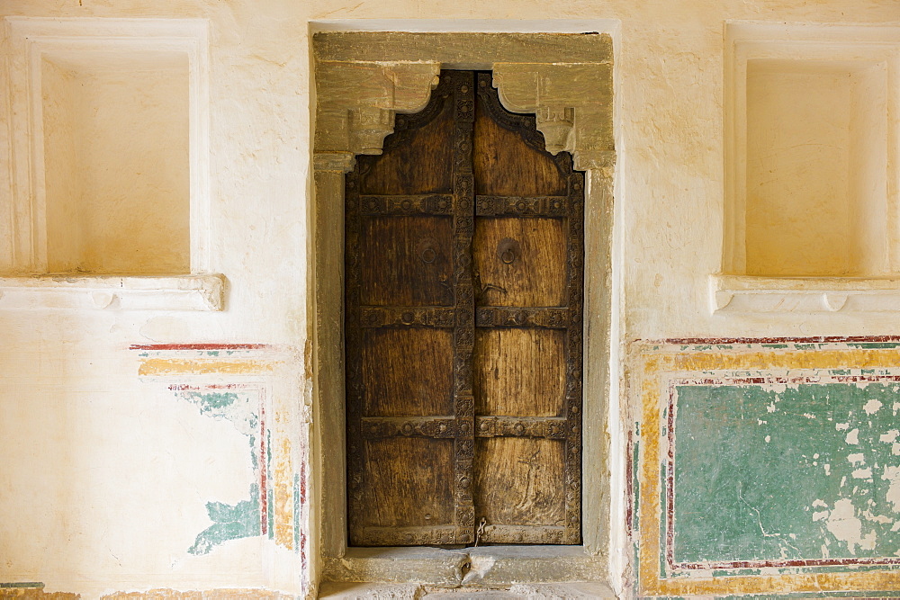 Hindu style traditional door in Acacia wood at the 16th Century Amber Fort in Jaipur in Rajasthan, Northern India